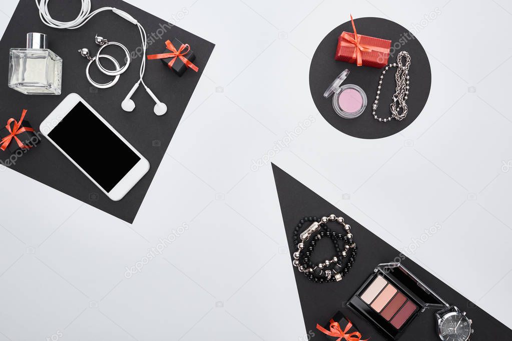 top view of gadget, gift boxes, perfume, bracelets, decorative cosmetics, earrings, earphones