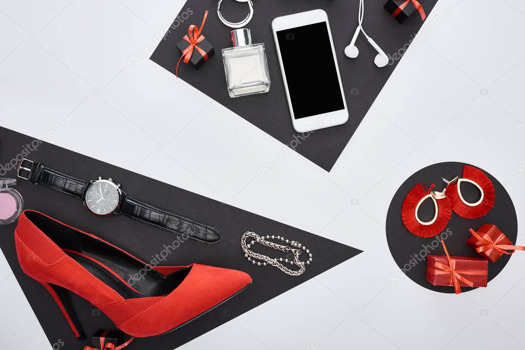 top view of gadget, gift boxes, perfume, bracelets, blush, earrings, earphones, wristwatch, shoes