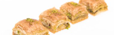 traditional turkish honey baklava with nuts isolated on white, panoramic shot clipart