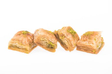 row of traditional turkish honey baklava with nuts isolated on white clipart