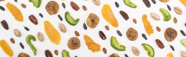 top view of delicious assorted nuts, dried fruits and candied fruit isolated on white, panoramic shot clipart