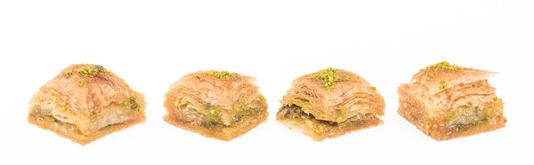 traditional turkish honey baklava with nuts in row isolated on white, panoramic shot