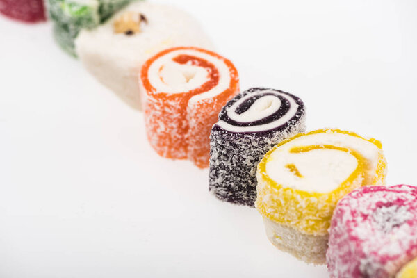 assorted delicious turkish delight in coconut flakes isolated on white