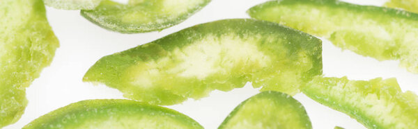 close up view of green sugary candied fruit isolated on white, panoramic shot