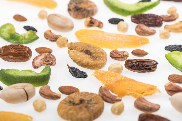 close up view of assorted nuts, dried fruits and candied fruit isolated on white