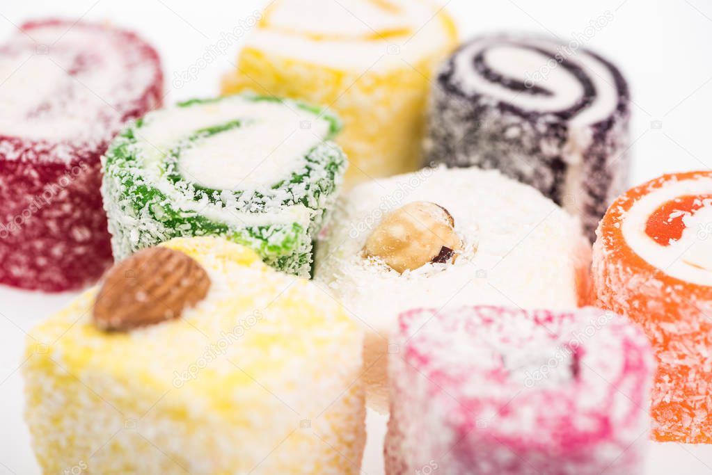 close up view of assorted delicious turkish delight in coconut flakes isolated on white