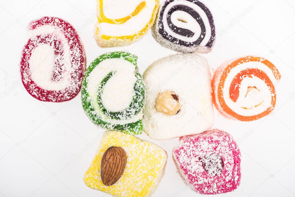 top view of assorted delicious turkish delight in coconut flakes isolated on white