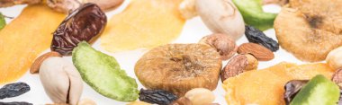 close up view of Turkish assorted nuts, dried fruits and candied fruit isolated on white, panoramic shot clipart