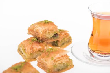 close up view of cup of tea near baklava isolated on white clipart
