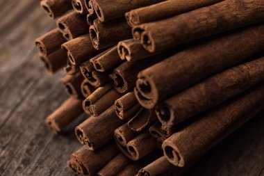 close up view of cinnamon sticks on wooden rustic table clipart