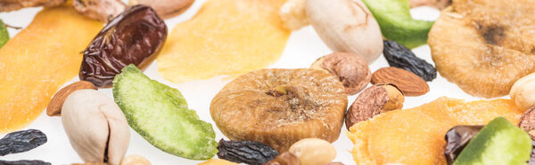close up view of Turkish assorted nuts, dried fruits and candied fruit isolated on white, panoramic shot