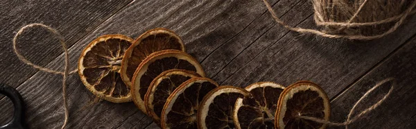 Top View Thread Dried Citrus Slices Wooden Background Panoramic Shot — Stock Photo, Image