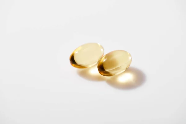 Two Golden Fish Oil Capsules White Background — Stock Photo, Image