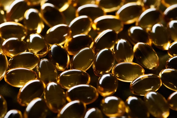 Close View Shiny Golden Fish Oil Capsules Black Background Dark — Stock Photo, Image