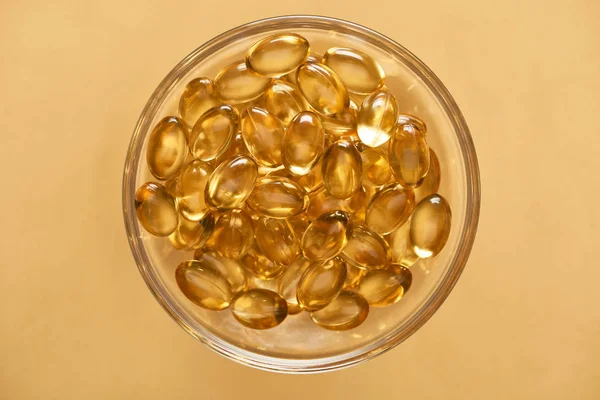 Top View Shiny Golden Fish Oil Capsules Glass Bowl Yellow — Stock Photo, Image