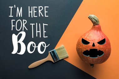 top view of Halloween pumpkin near paintbrush on black and orange background with i am here for the boo illustration clipart