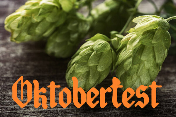 закрываем вид на зеленый хмель на деревянном столе с оранжевым ликером
