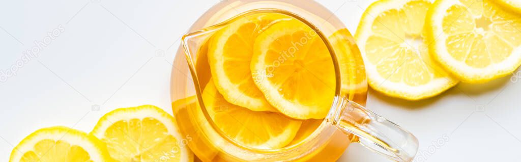 top view of hot tea with lemon slices on white background, panoramic shot