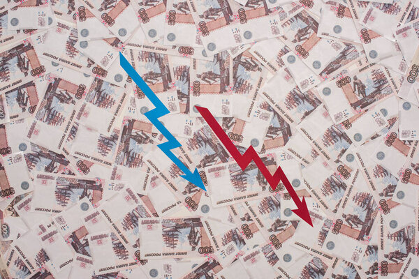 KYIV, UKRAINE - MARCH 25, 2020: top view of crisis graphs near russian rubles