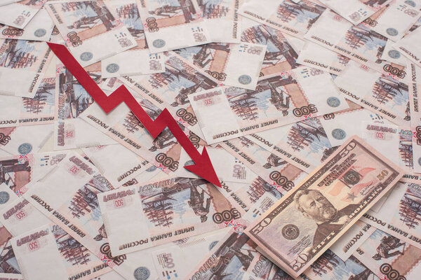 KYIV, UKRAINE - MARCH 25, 2020: top view of crisis graph near russian rubles and dollar banknote 