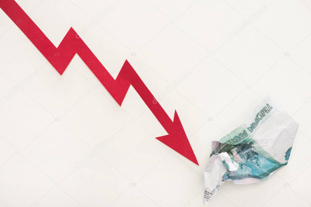 top view of crisis graph near russian ruble banknote isolated on white 
