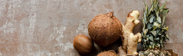 вид сверху на тропические свежие фрукты и корень имбиря на выветренной поверхности, панорамный урожай
