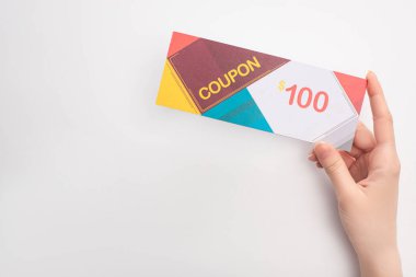 Cropped view of woman holding coupon with 100 dollars sign on white background clipart