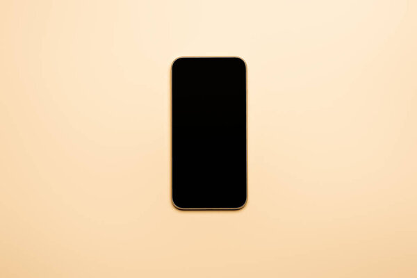 вид сверху смартфона с пустым экраном на бежевом
