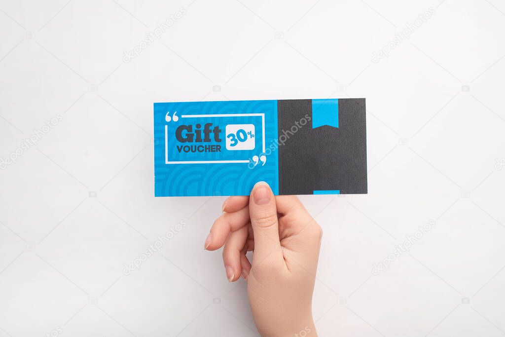 Top view of woman holding gift voucher with 30 percents lettering on white background