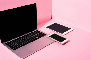 modern gadgets with blank screens on pink background clipart