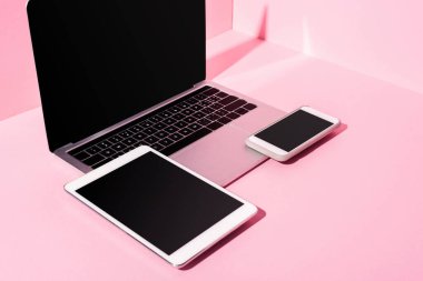modern gadgets with blank screens on pink background clipart