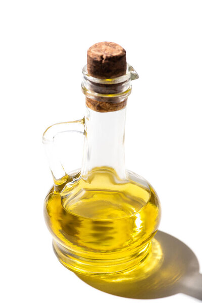 olive oil in glass jar with cork on white background