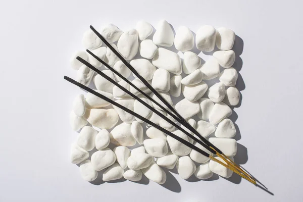 Beyaz Arkaplandaki Taşlardan Yapılmış Kare Üzerindeki Aroma Çubuklarının Üst Görünümü — Stok fotoğraf