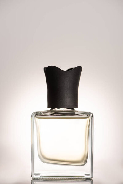 perfume in bottle on beige background
