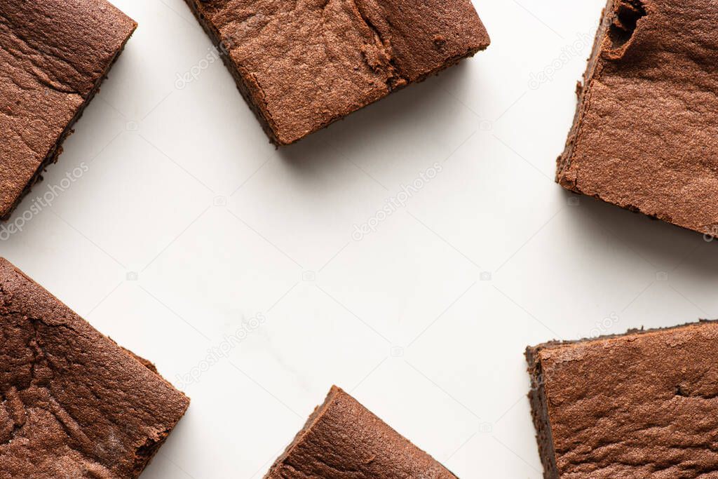 top view of delicious brownie pieces on white background