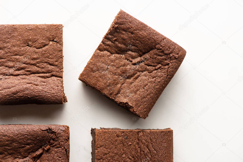 top view of delicious brownie pieces on white background
