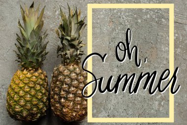 top view of ripe pineapples on grey concrete surface with oh summer illustration clipart