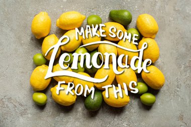 top view of colorful avocado, limes and lemons on grey concrete surface, make some lemonade from this illustration clipart