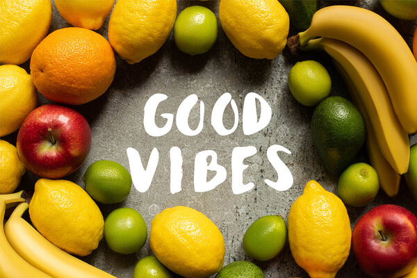 top view of tasty colorful fruits on grey concrete surface, good vibes illustration