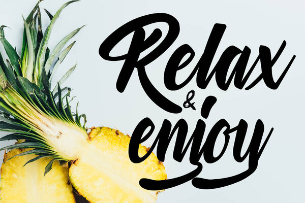 top view of juicy pineapple halves on white background with relax and enjoy illustration