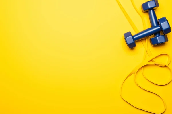 Top View Blue Dumbbells Resistance Band Yellow Background — Stock Photo, Image