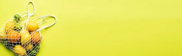 Sarı Arka Planda Iplik Torbasında Olgun Narenciye Meyvelerinin Üst Görüntüsü — Stok fotoğraf