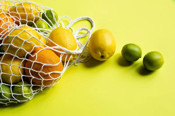 Ripe Whole Citrus Fruits String Bag Yellow Background — Stock Photo, Image