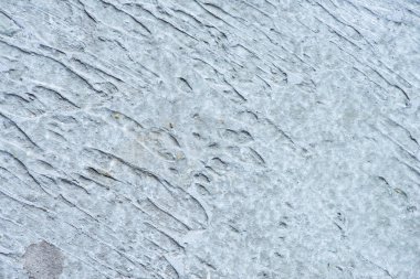 Sert, soyut, gri beton desenli duvar.