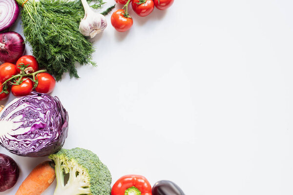 frame of colorful assorted fresh vegetables on white background