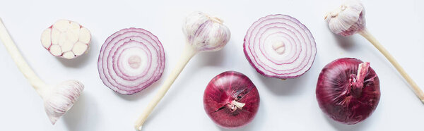 top view of cut and whole red onion and garlic on white background, panoramic shot