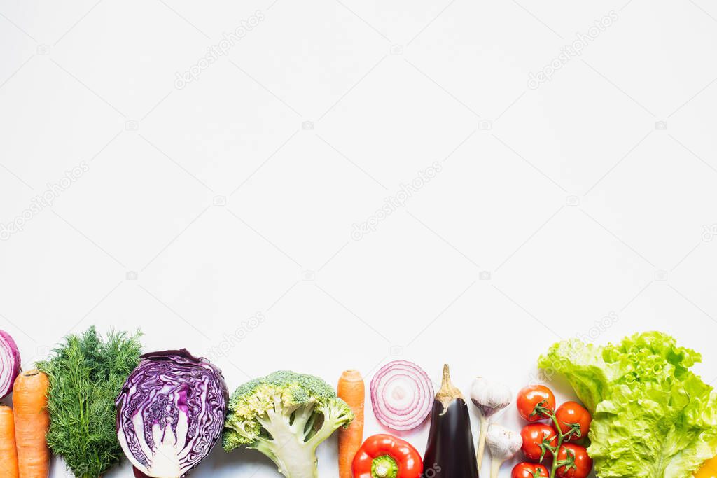 border of colorful assorted fresh vegetables on white background with copy space