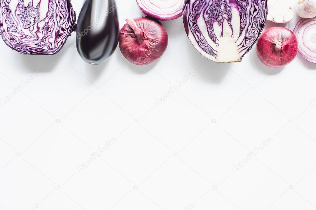 border of red onion, red cabbage, eggplant and garlic on white background