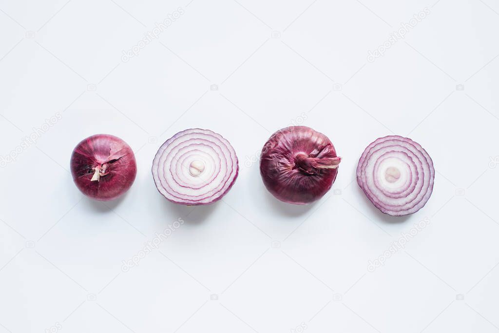 top view of cut and whole red onion on white background
