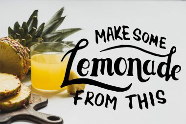 fresh pineapple juice near sliced fruit on wooden cutting board near make some lemonade from this lettering on white  clipart